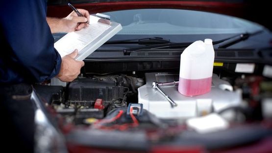 One of our Mechanics servicing a car engine