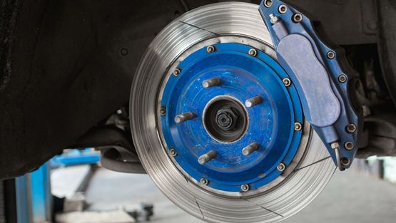 A C.A.R.S. mechanic repairing a car’s brakes.